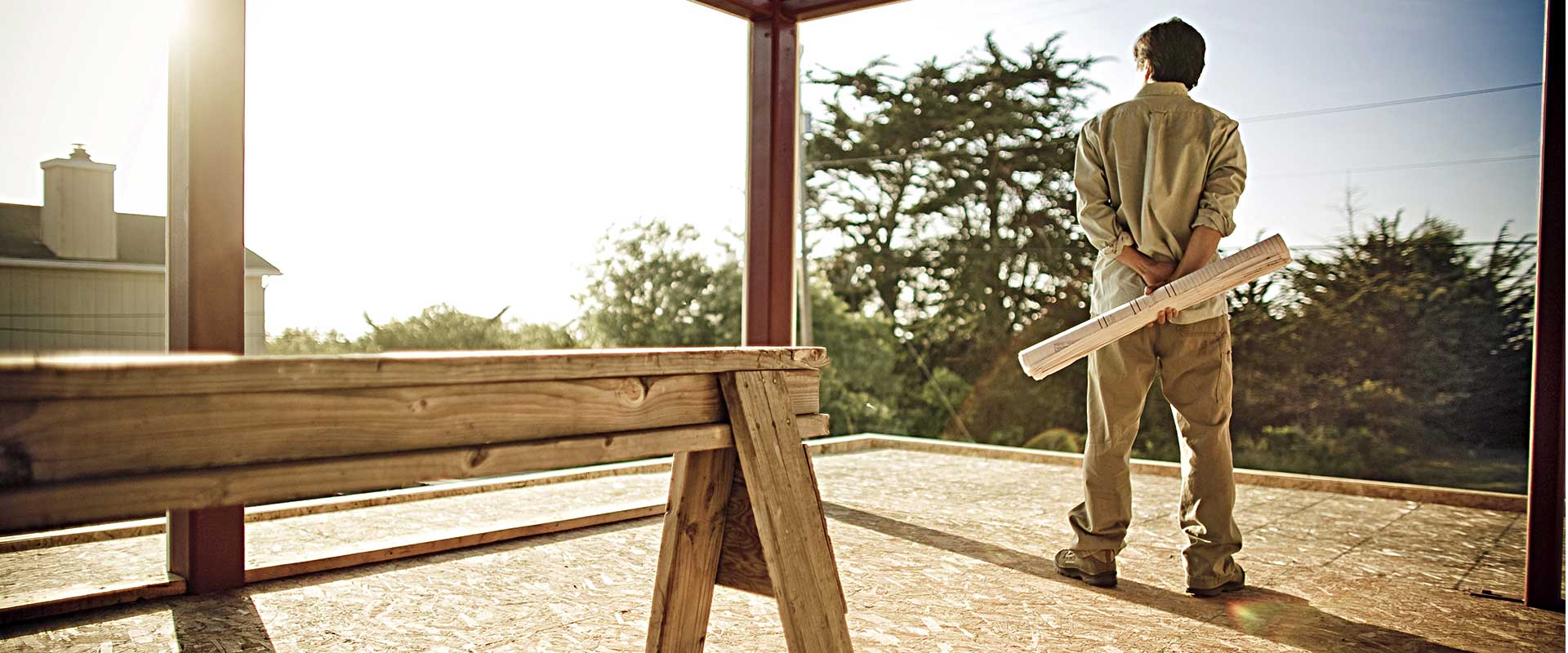 Contractor looking out from the second floor of a house under construction